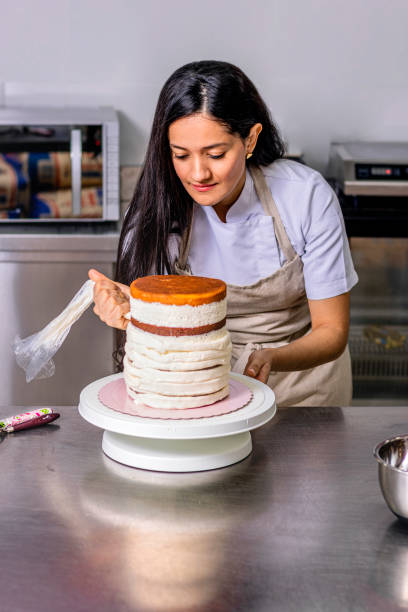 istock Colombian Pastry Chef. Chef using the piping bag 1477195072