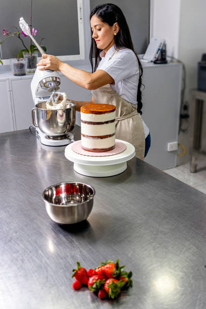 istock Colombian Pastry Chef. Process of creating a strawberry cake. 1477195085