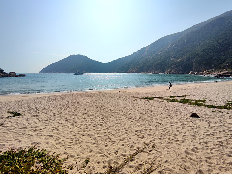 Man on the sandy beach at Sham Wan, Lamma Island, the only site in Hong Kong and one of the few sites in South China Sea at which Green Turtles nest from time to time.
