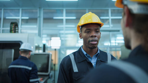 istock Diversity colleague of industry heavy team engineer. while checking and discuss maintenance machine line production factory 1477196360