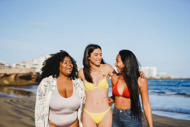 istock Young multiracial women having fun together during summer vacation on the beach 1477196908