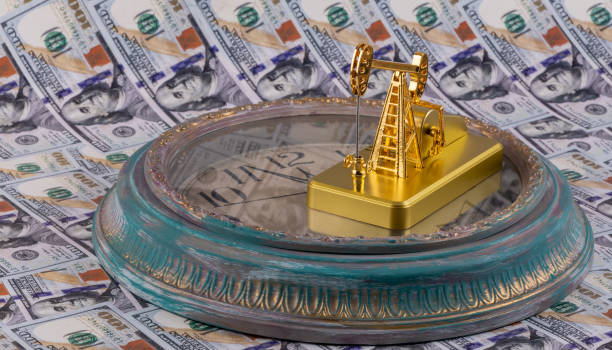 Golden oil pump and antique wall clock on the background of American dollars Golden oil pump and antique wall clock on the background of American dollars gold ira rollover guide stock pictures, royalty-free photos & images