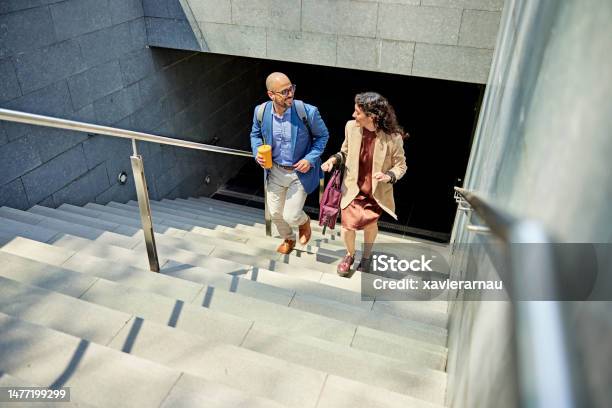 Smiling Business Partners Walking Up Staircase Stock Photo - Download Image Now - Staircase, Steps, Moving Up