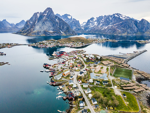 Aerial landscapes of the city of Reine in Lofoten, Norway, during spring on a clear day with clouds