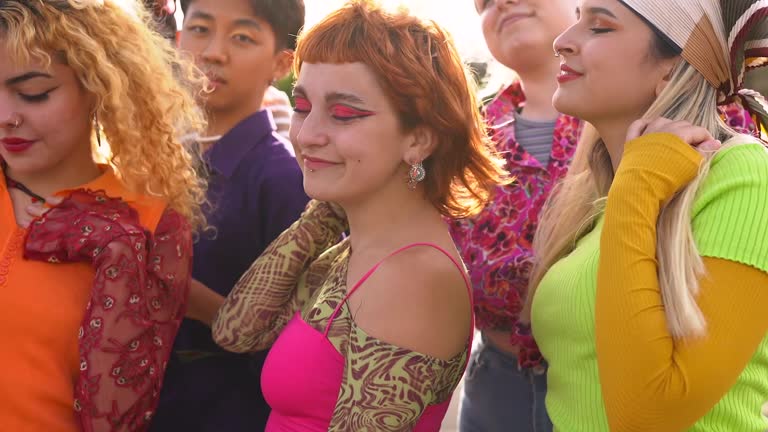 Group of multiracial young people dancing together at music concert outdoor during summer time