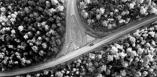 Aerial view of cars on crossroad in the forest in autumn, Chianti region, Tuscany, Italy.