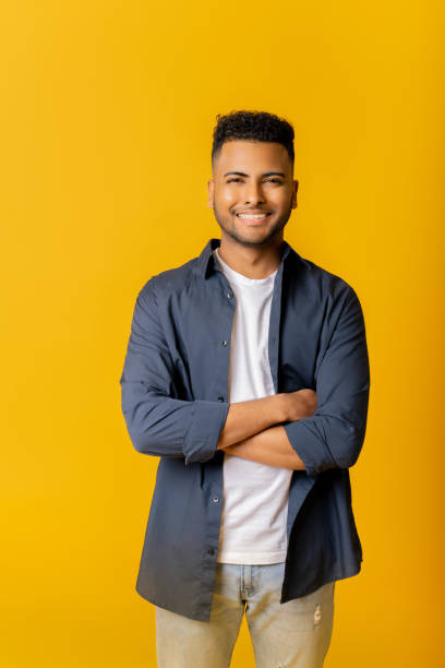 istock Nice smiling indian male entrepreneur isolated on yellow 1477205408