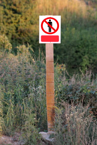 istock Restricted area do not enter authorized personnel only prohibited access with person icon metal sign on top of wooden board 1477206736