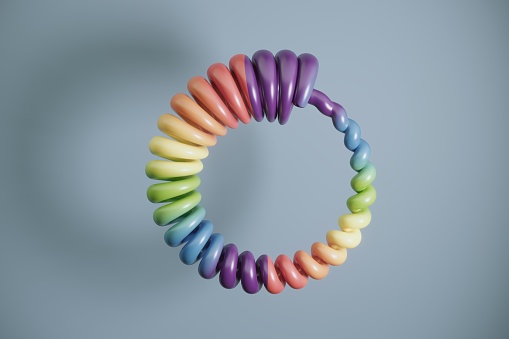 Multi colored spiral shaped circle on blue background. (3d render)