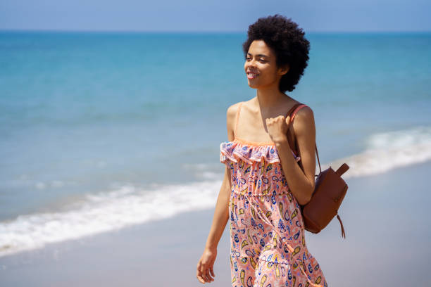 istock Young ethnic female spending summer vacation on seashore 1477210946