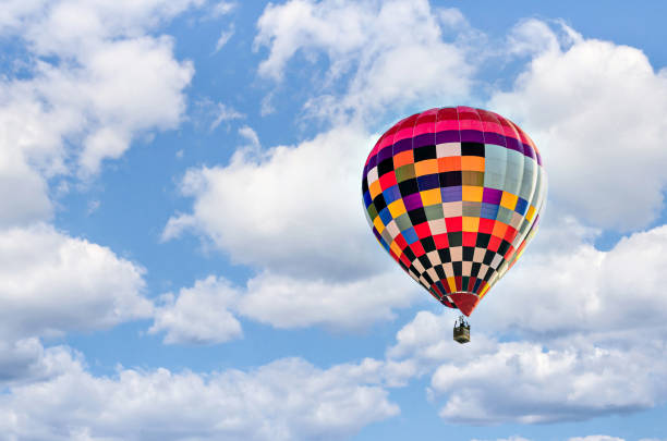 istock Hot air balloon flight over blue sky 1477211114
