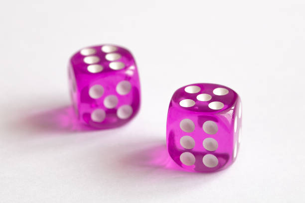 istock two purple dices on white background 1477211383