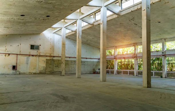 istock industrial warehouse or commercial area in an architectural background with bare cement  pillars supporting a ceiling before construction 1477212997