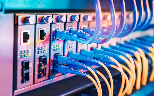 Fiber Optical cables connected to an optic ports and Network cables connected to ethernet ports