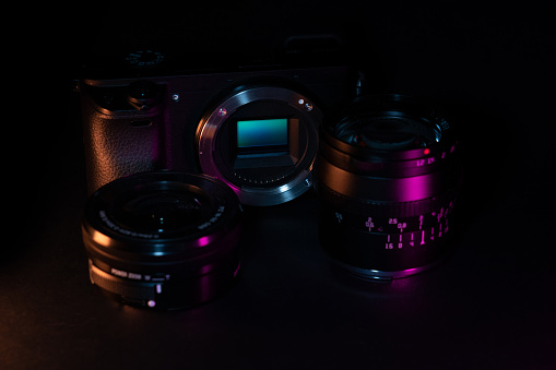 Digital camera with lenses in dark studio environment