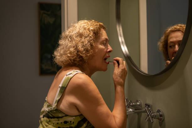 istock Senior female putting on makeup 1477217396
