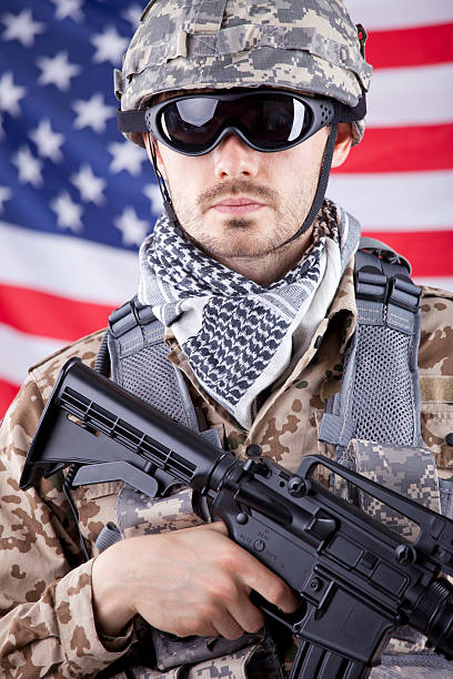 istock Soldier with gun over american flag 147721752