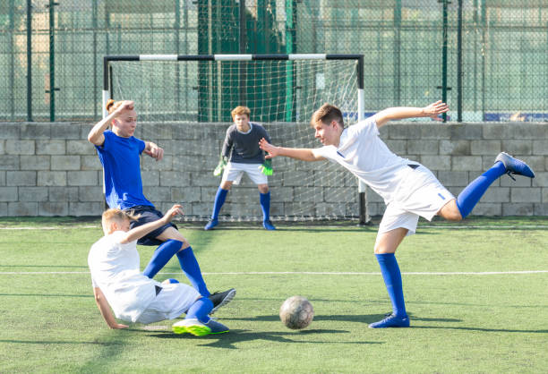 istock Junior football teams having scrimmage 1477220815