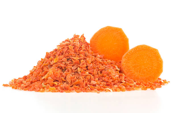 chopped dried carrot and fresh carrot slices isolated on a white background - carotene imagens e fotografias de stock