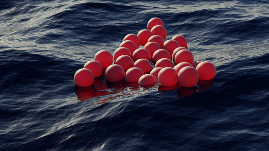 Spherical balloons float on the water surface of the ocean in un a surreal scene. CGI