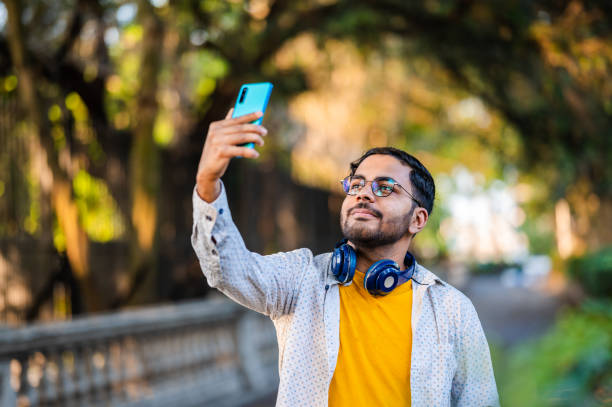 istock Young man taking selfie with smartphone while travel 1477224991