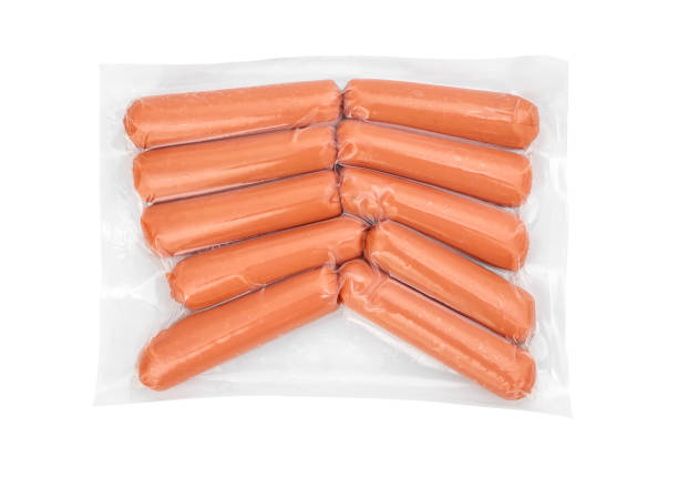 Boiled sausages in vacuum packaging. Isolated on white. Top view. stock photo