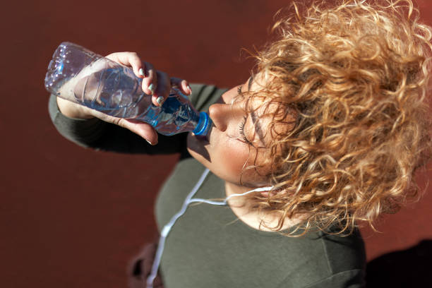 istock Overweight woman drinking water 1477228680