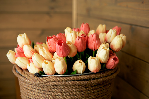 large bouquet of tulips in a wicker basket