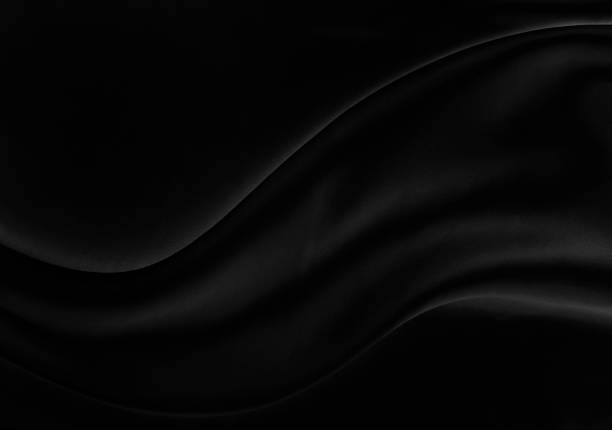 istock Black gray satin dark fabric texture luxurious shiny that is abstract silk cloth background with patterns soft waves blur beautiful. 1477230838