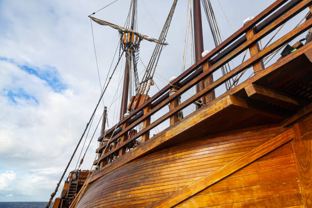 istock Old wooden ship with lowered sails, view from below. 1477235645