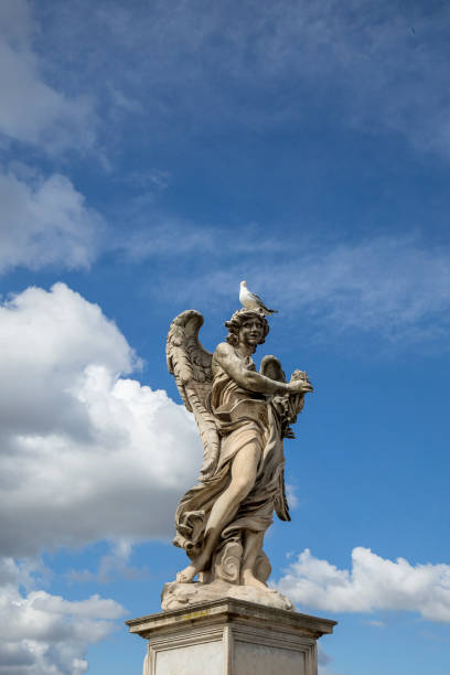 angel statue on a pedestal at ponte sant angelo in rome, italy. - roman statue angel rome imagens e fotografias de stock