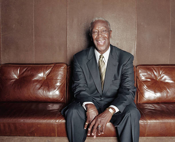 istock Mature man sitting on sofa, laughing, portrait 147723801