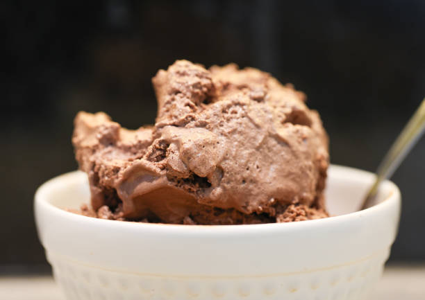 istock Chocolate ice cream in a white bowl. Black background. 1477241072