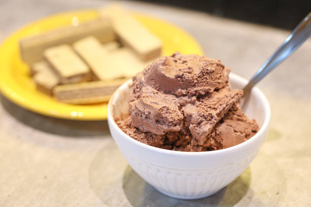istock Chocolate ice cream in a white bowl with chocolate filled wafer cookies 1477241248