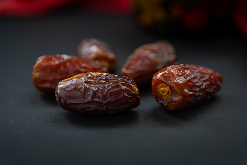 Closeup of sweet, soft and moist natural dates isolated with a dark background.