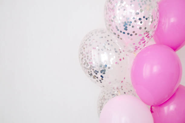 istock A bundle of pink and transparent air balloons with silver confetti, copy space for your text, tender pastel colors for a girlish party 1477246923