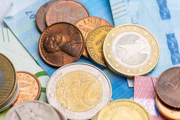 istock Assortment of coins on bank notes from different countries. 1477250369