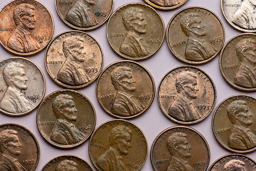 Old cent coins on purple background.