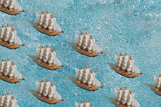 A wooden sailing ship on a blue towel. Pattern.