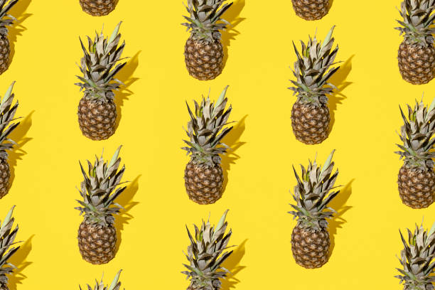 istock Pineapple on a yellow background. Minimal and modern design and pattern. 1477250842