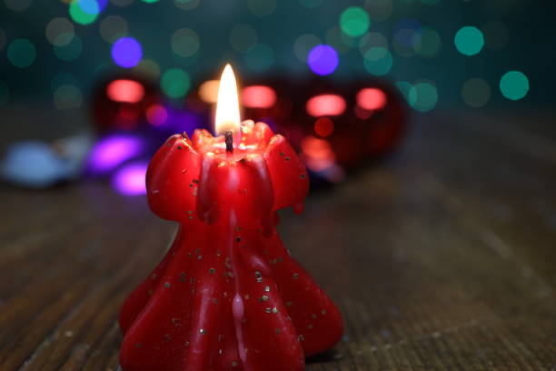 New Years motive. Burning candle on a blurred background.