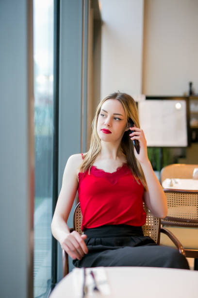 istock Teen talking on mobile phone in a bar 1477254947