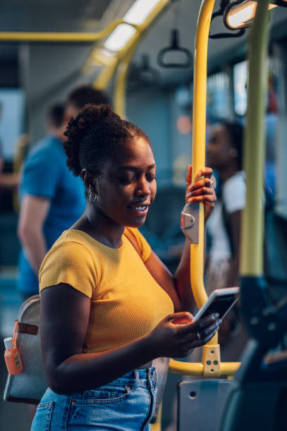 istock African american woman riding in a bus and using a smartphone during a night 1477258500