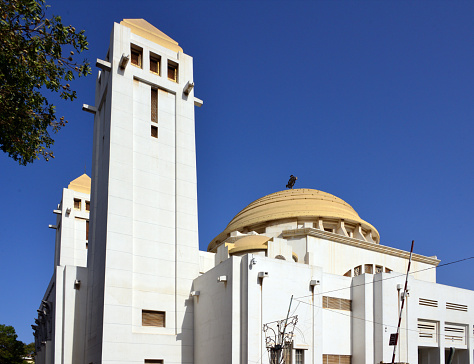 Dakar, Senegal: Catholic Cathedral of Our Lady of Victories, also known as Cathedral of African Remembrance, is the largest church in Dakar and the seat of the archdiocese. The monumental building, designed by the architect Charles-Albert Wulffleff, draws its inspiration from multiple sources: neo-Sudanese style towers, Byzantine cupolas and terraces, caryatids to which young Fulani girls have lent their features. \nIt is located on Boulevard de la République in the Dakar-Plateau district.