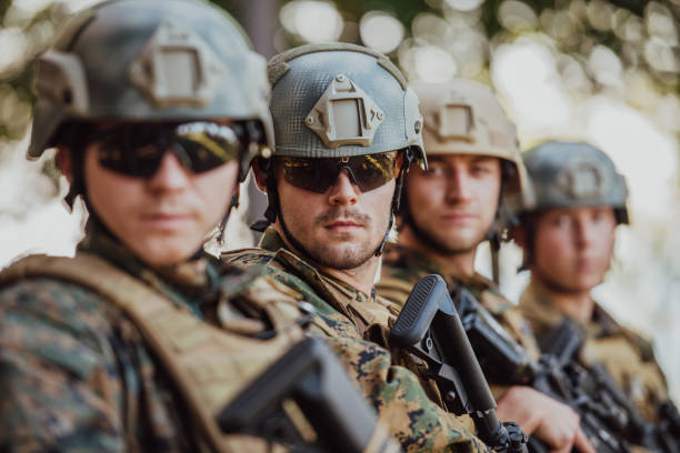 soldier fighters standing together with guns. group portrait of us army elite members, private military company servicemen, anti terrorist squad - dream time imagens e fotografias de stock