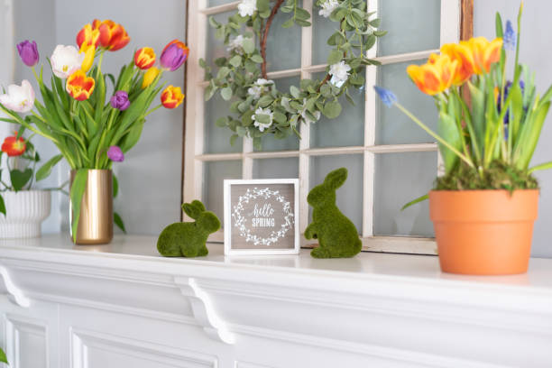 istock White mantel decorated for spring with colorful tulips and bunnies 1477265032