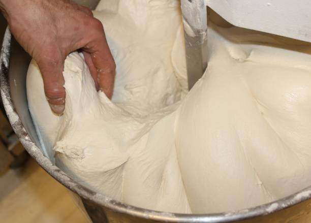 istock Mechanical pizza mixer at work. Raw dough in rotation. 1477267755