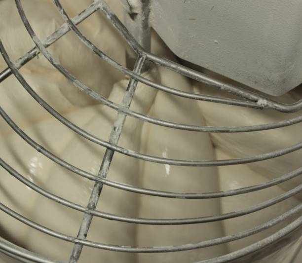 istock Mechanical pizza mixer at work. Raw dough in rotation. 1477267789