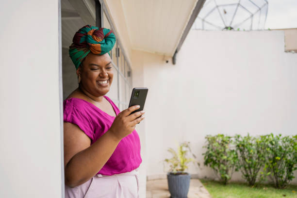 istock Black mature woman using smart phone 1477272348