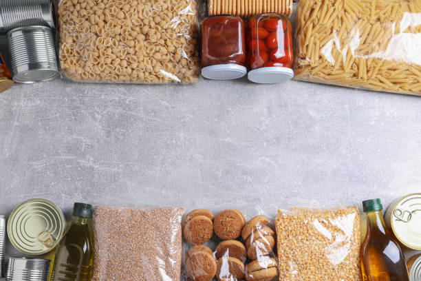 istock Different products on light grey table, flat lay with space for text. Food donation 1477275514